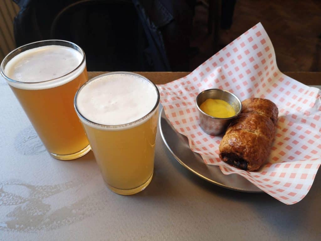 Typical English lunch. Sausage roll and a beer.