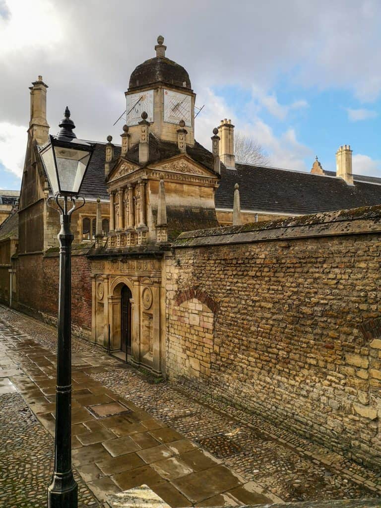 A an example of a typical Cambridge streets with buildings during an Autumn wet weather.