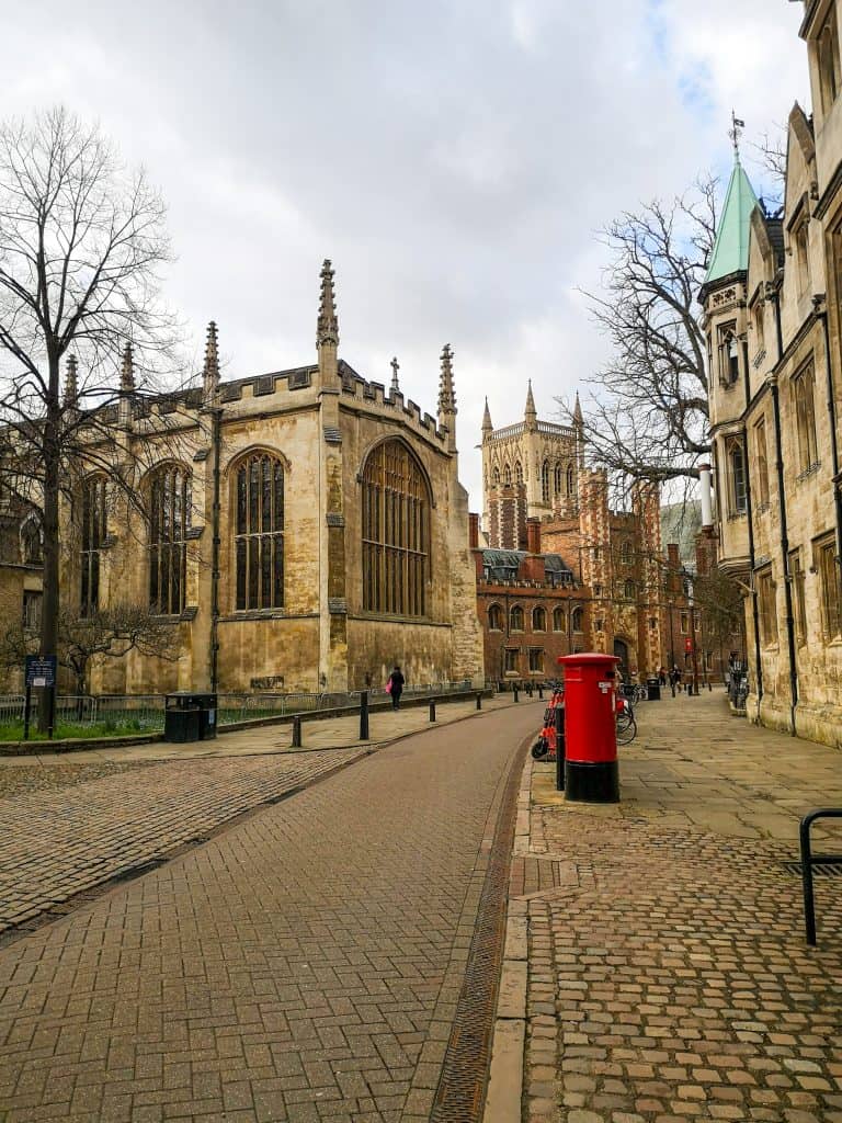 A typical example of Cambridge streets. Autumn weather with a red post box. The shot captures the St John's College.