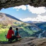 A couple watching a view from a cave in Scotland.