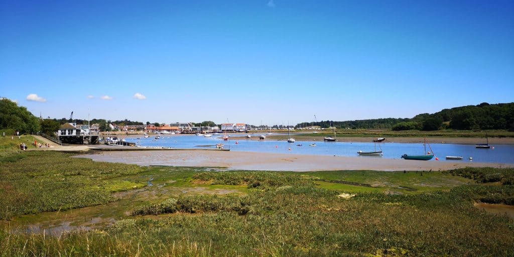 Views at the river Deben in Woodbridge Suffolk with boats on a sunny day.