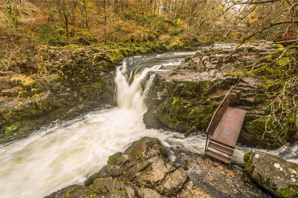 Skelwith Force waterfall in winter with bridge.