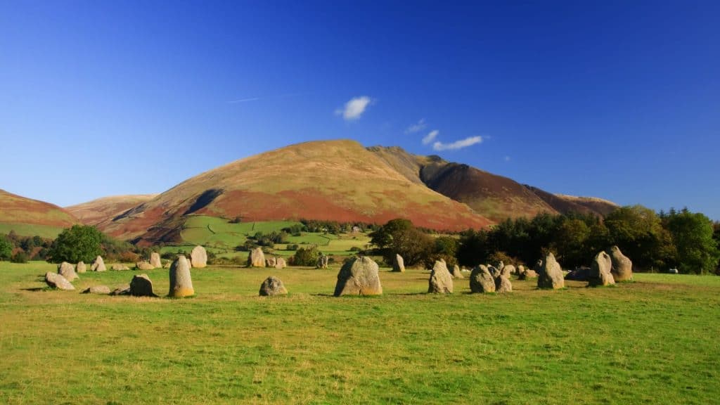 View at the stone circle on a sunny day with a hill at back.