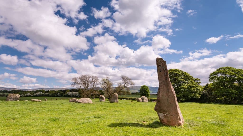 Long Meg stone on a sunny day with clouds.