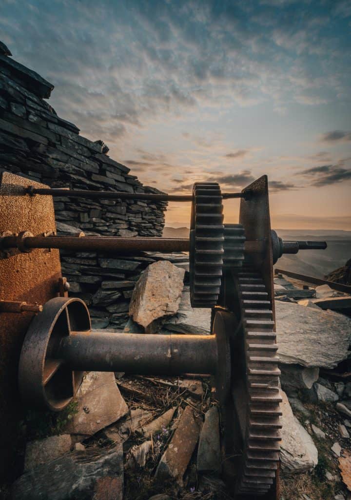 Old machinery in the Coniston Copper Mine at sunset.