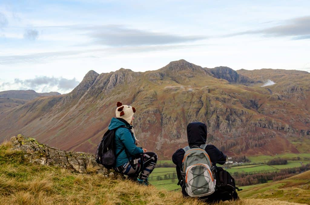 A couple looking at one of the pikes in Lake District in winter.