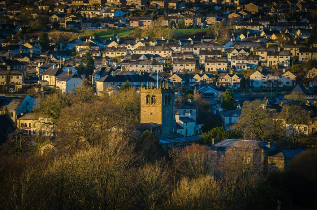 Kendal town centre with church and houses in sunshine.
