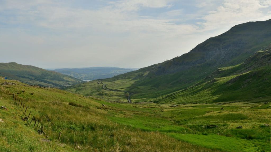 Road in between two massive hills.