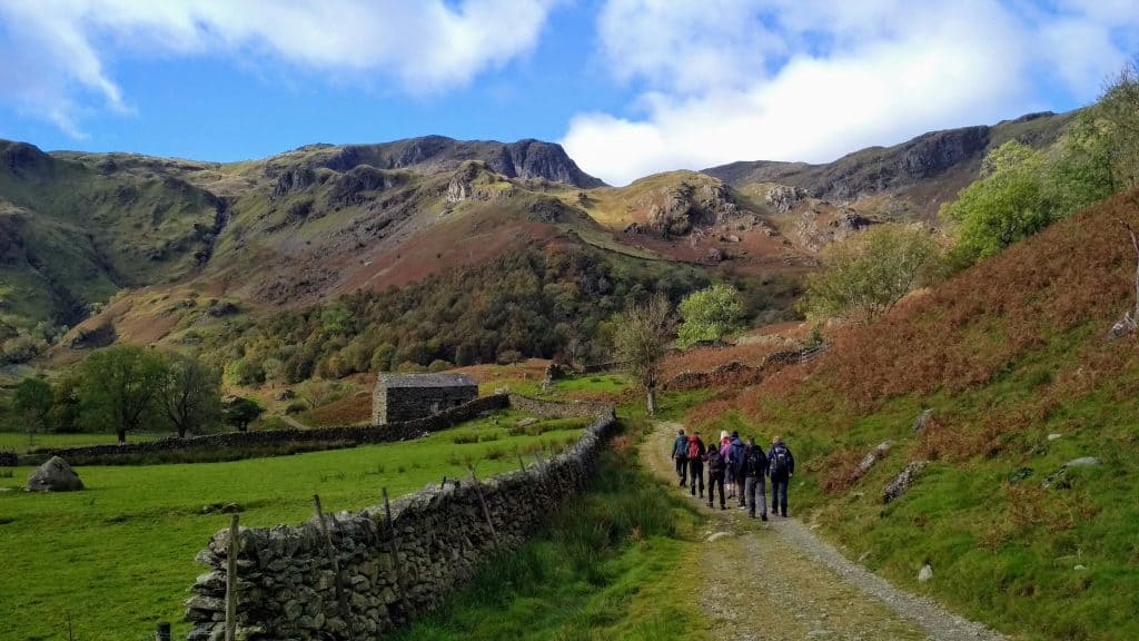 A group of people hiking in Lake District in spring.