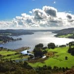Walks around Windermere - A view at a lake and green hills on a sunny day.