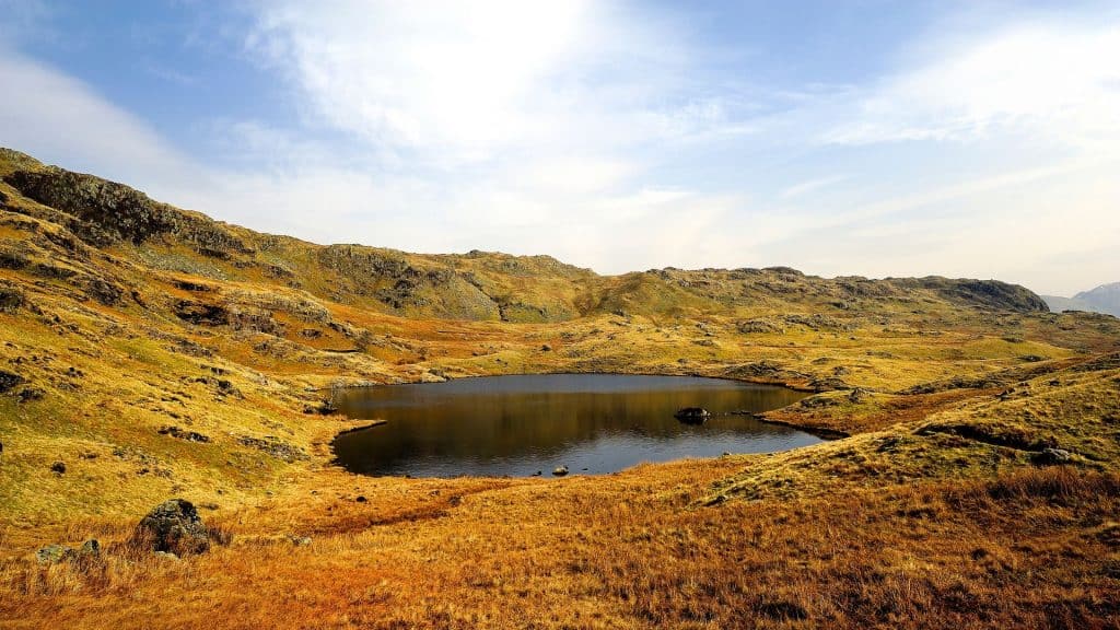 A view at a small lake in autumn months in the Lake District.