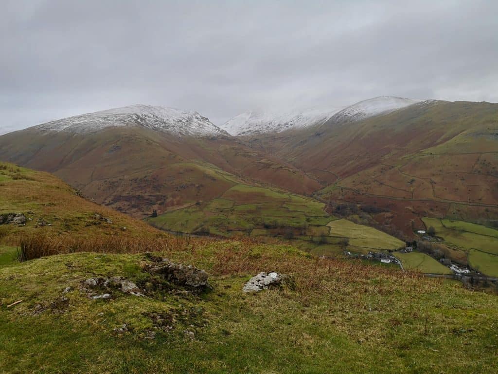 Lake District hills in winter with snowy peaks.