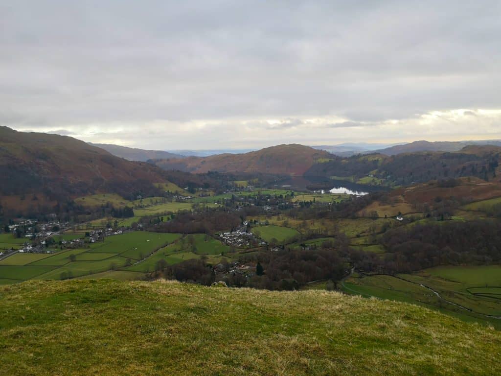 View at a winter landscape with lake and hills without snow in the Lake District.