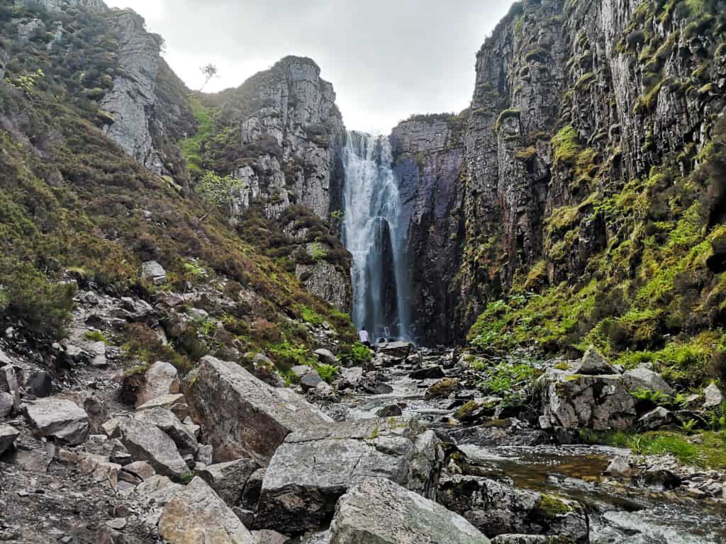 Allt Chranaidh waterfall with cliffs and river, must on every Scotland Itinerary.