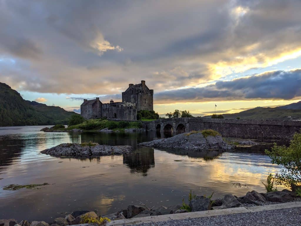 View at the Eilean Donan Castle with its bridge during sunset, a must place on Scotland itinerary.