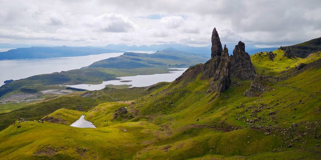 View at the Old Man of Storr on the Isle of Skye, views showing the rock formation of the Storr, landscape and surrounding sea and lakes in summer.