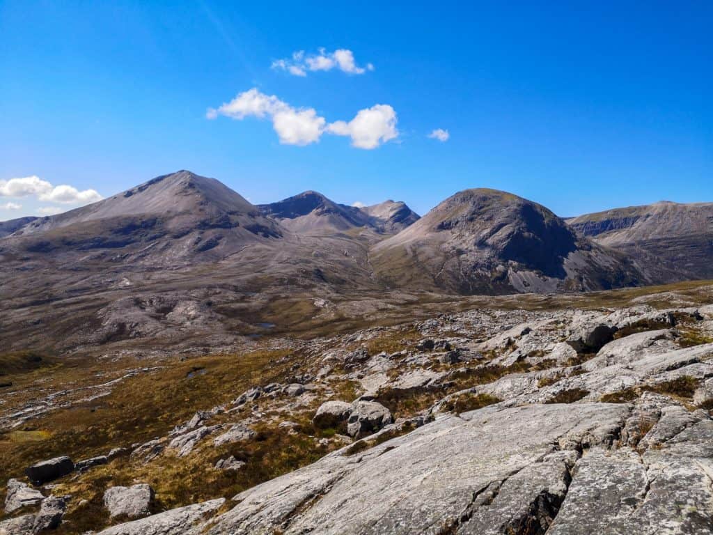 Hiking on the NC500 route, views showing mountains on a sunny day.