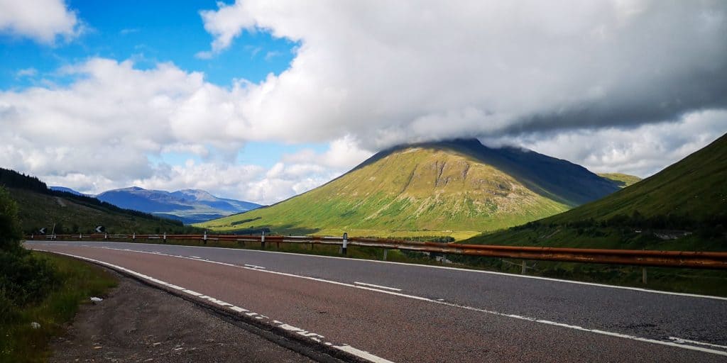 A view rom a road on a mountain covered in clouds during Scotland road trip.