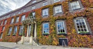 The Angel Hotel in Bury St Edmunds in autumn, with colourful leaves covering the building.