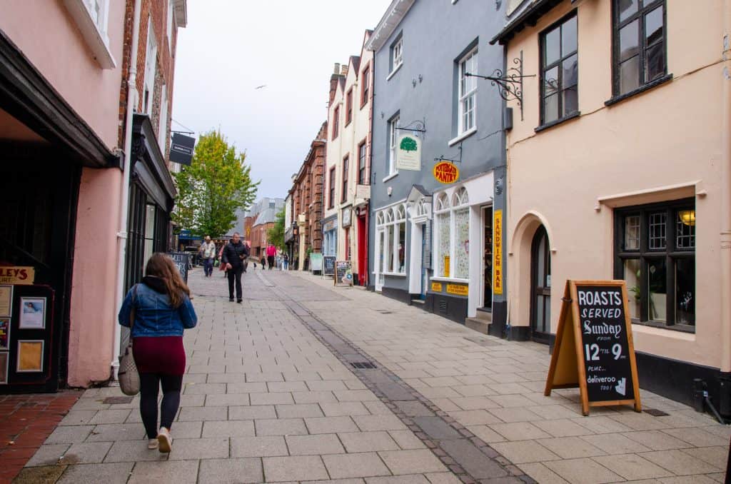 View at the Norwich Lanes with shops and people walking.