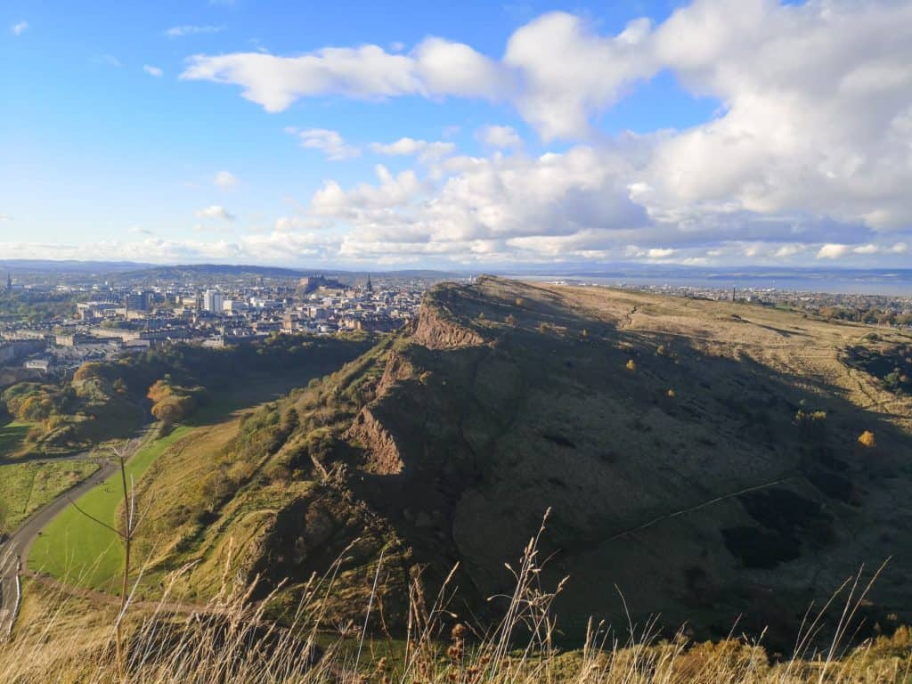 View at the Salisbury Crags and city from one of the pathways to the Arthur Seat in Edinburgh.