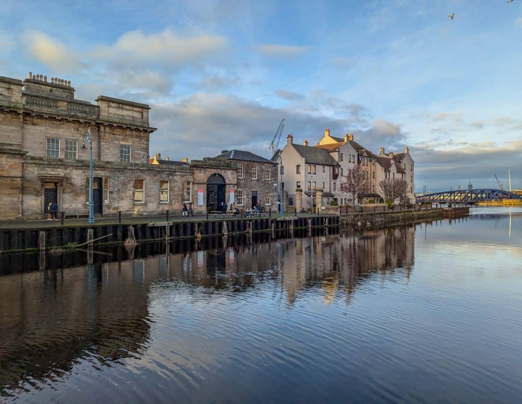 A view of water and buildings in Leith in Edinburgh. Visiting Leith is a perfect activity for a weekend in Edinburgh.