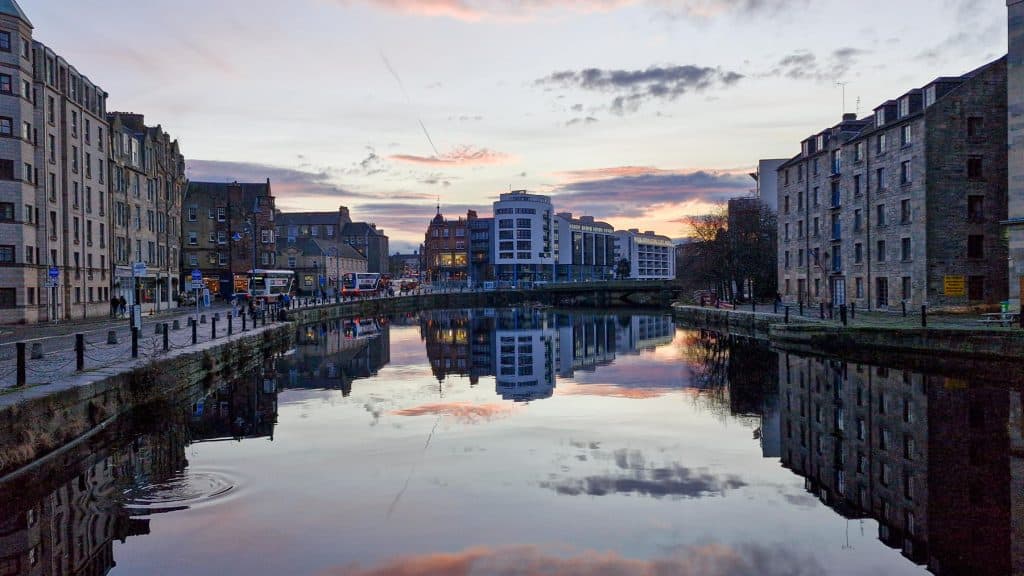 A view at water and buildings in Leith in Edinburgh during sunset. Visiting Leith is a perfect activity for a weekend in Edinburgh.