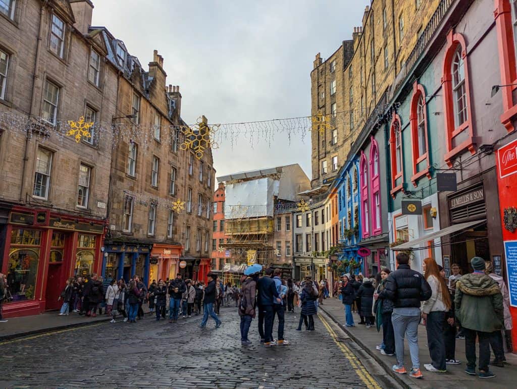 Victoria Street, Edinburgh Harry Potter style street, with Christmas decorations and people.