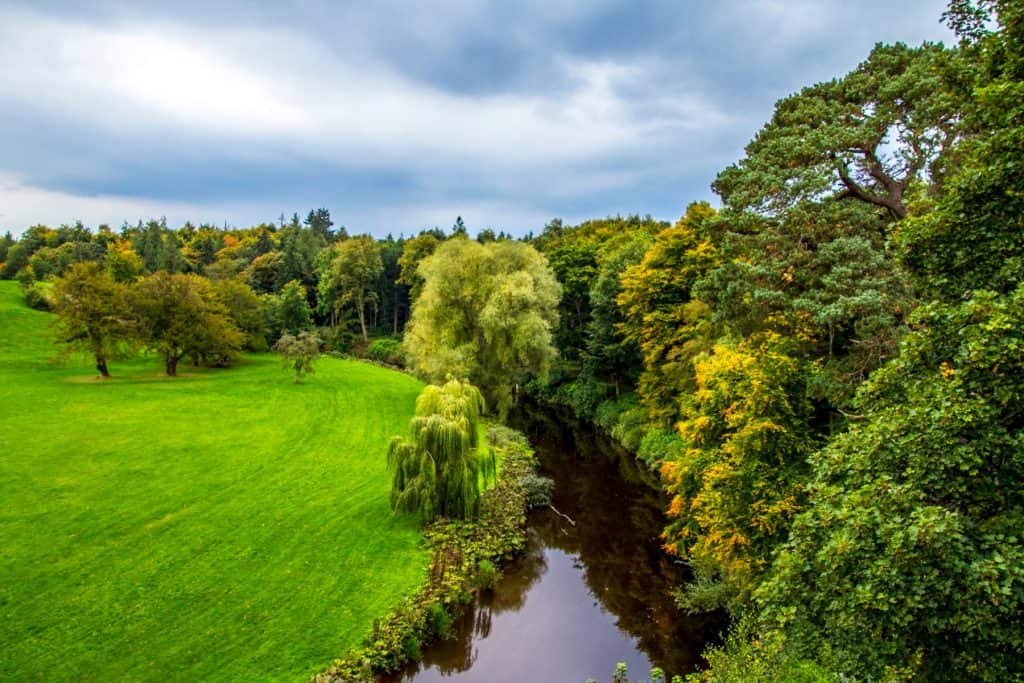 View at a river and trees in the Dalkeith Country Park in Scotland.