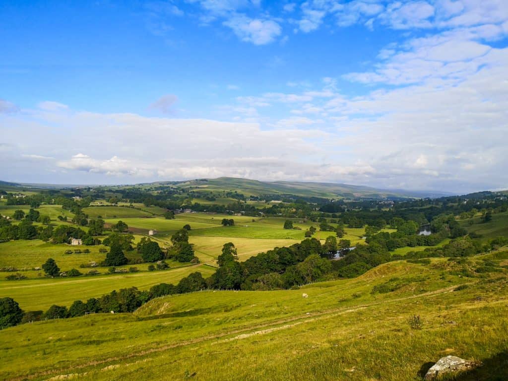 Views at rolling hills, pastures and river from a viewpoint in North Pennines.
