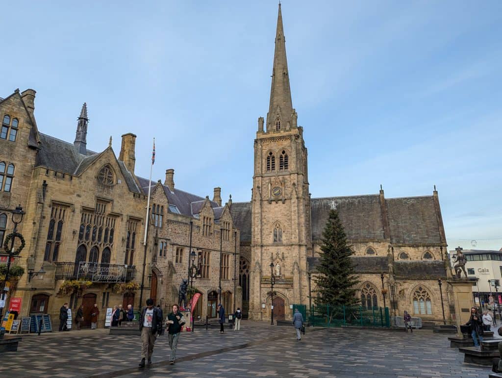 Market Square in Durham with a church, Town Hall and Christmas Tree. Exploring these places is among the best things to do for free in Durham.