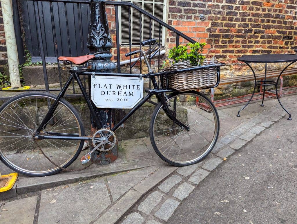 And old bike with Flat White Durham sign.