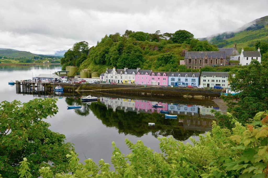 View at the colourful houses from the Portree viewpoint in summer on a cloudy day.