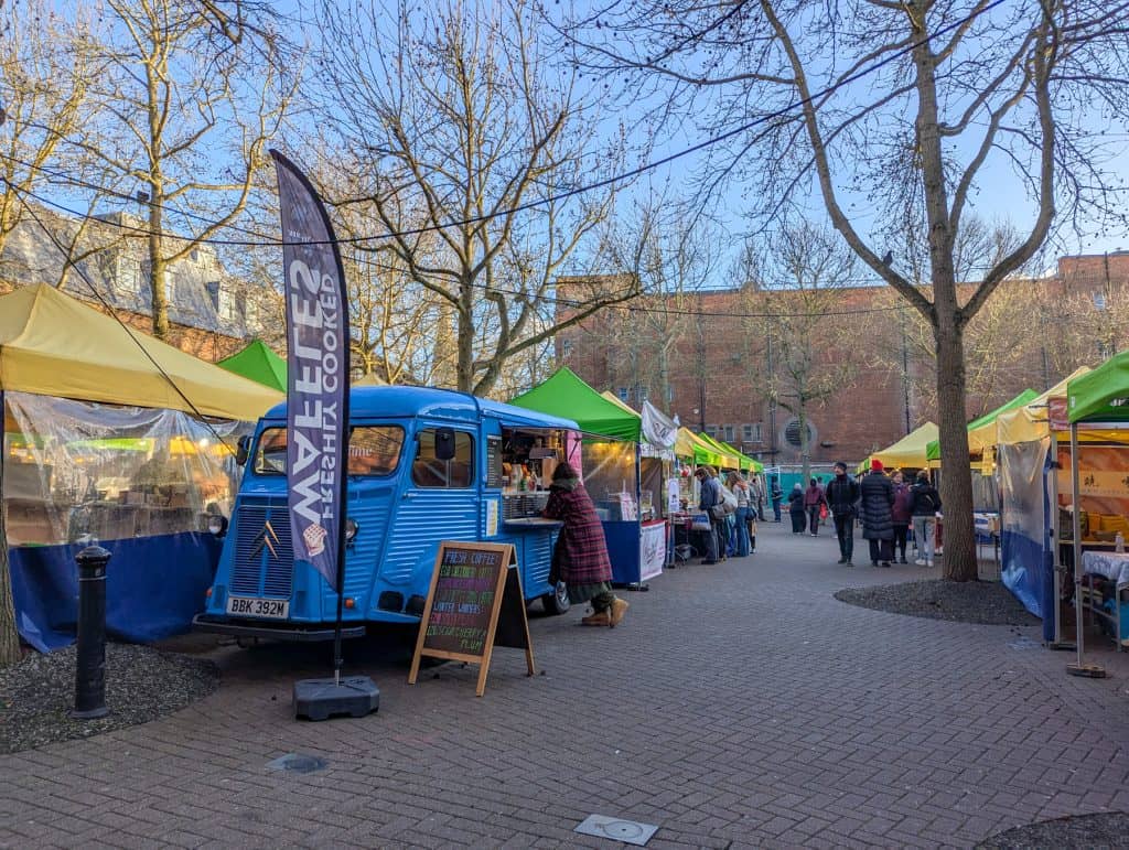 An outdoor Gloucester Green Market in Oxford with people.