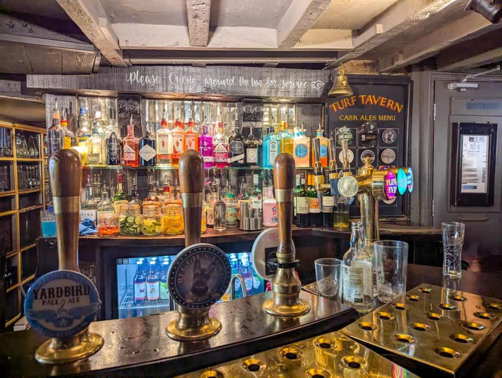 Inside the Turf tavern - an oldest bar with beers and drinks. A must stop on your day trip to Oxford.