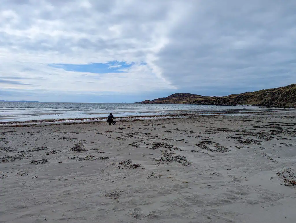 Ardalanish Beach on Isle of Mull - a person taking photos on the beach.