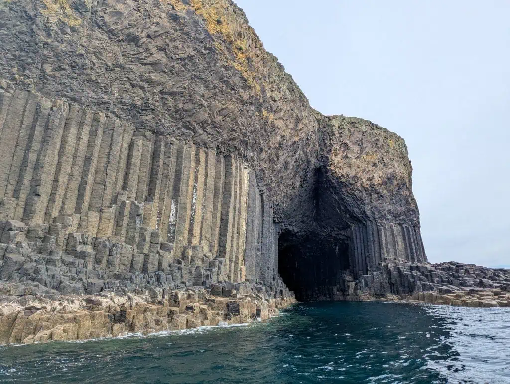 Detailed view at the geological landmark from a bot - Fingal's cave - one of the must things to do on Isle of Mull.