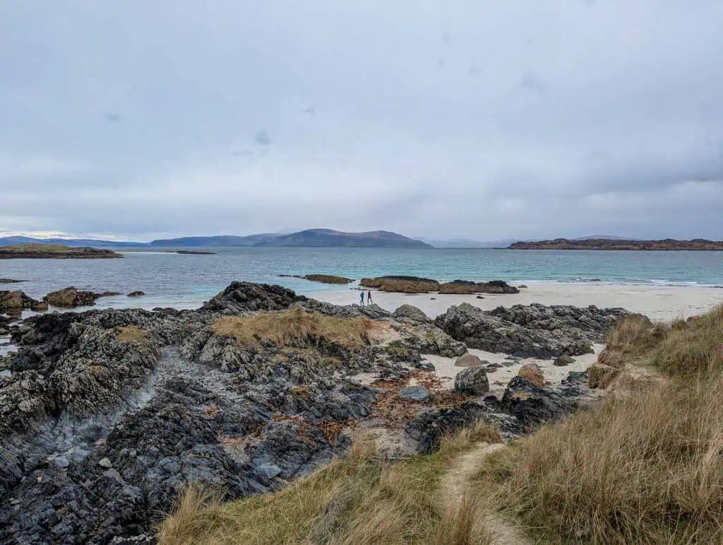 A beach on Iona island with stones on a cloudy day.