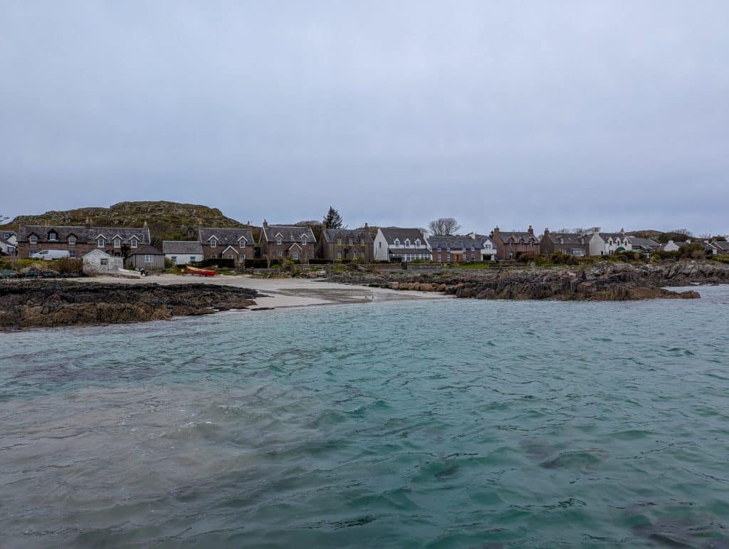 Iona island with cottages and tiny beach on a cloudy day.
