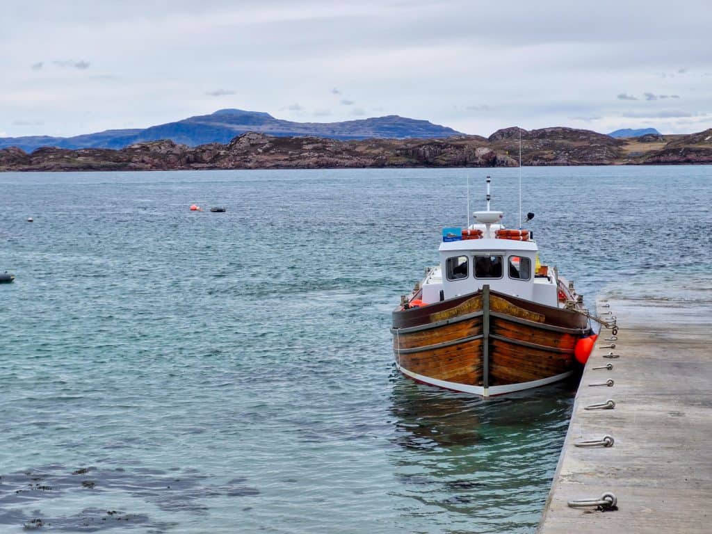 A boat of the Staffa Tour near the pier on the Iona island.