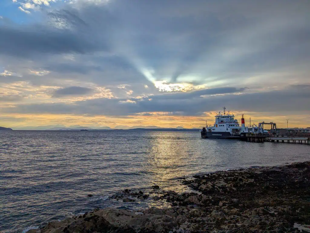 Sunrise in Craignure with the boat and mountains at back.