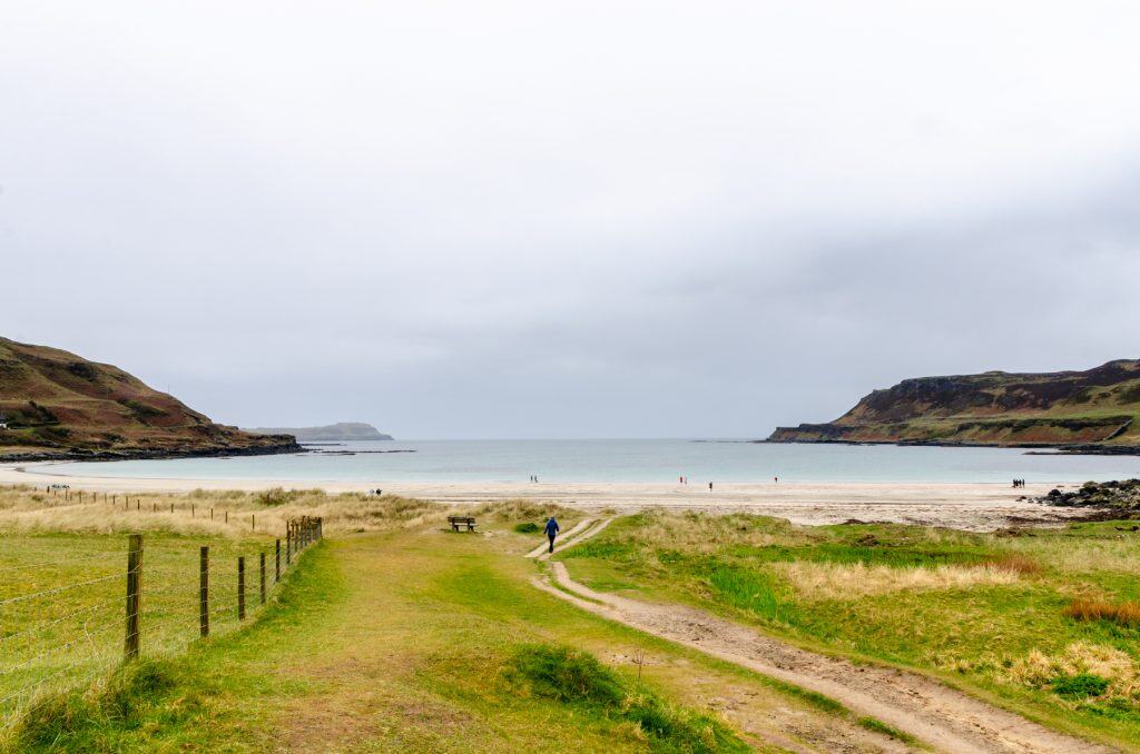 A view at a path that leads to Calgary Bay and beach on a cloudy day, one of the easiest Isle of Mull Walks. The walk around Calgary Bay combines white sand beaches with panoramic coastal views.