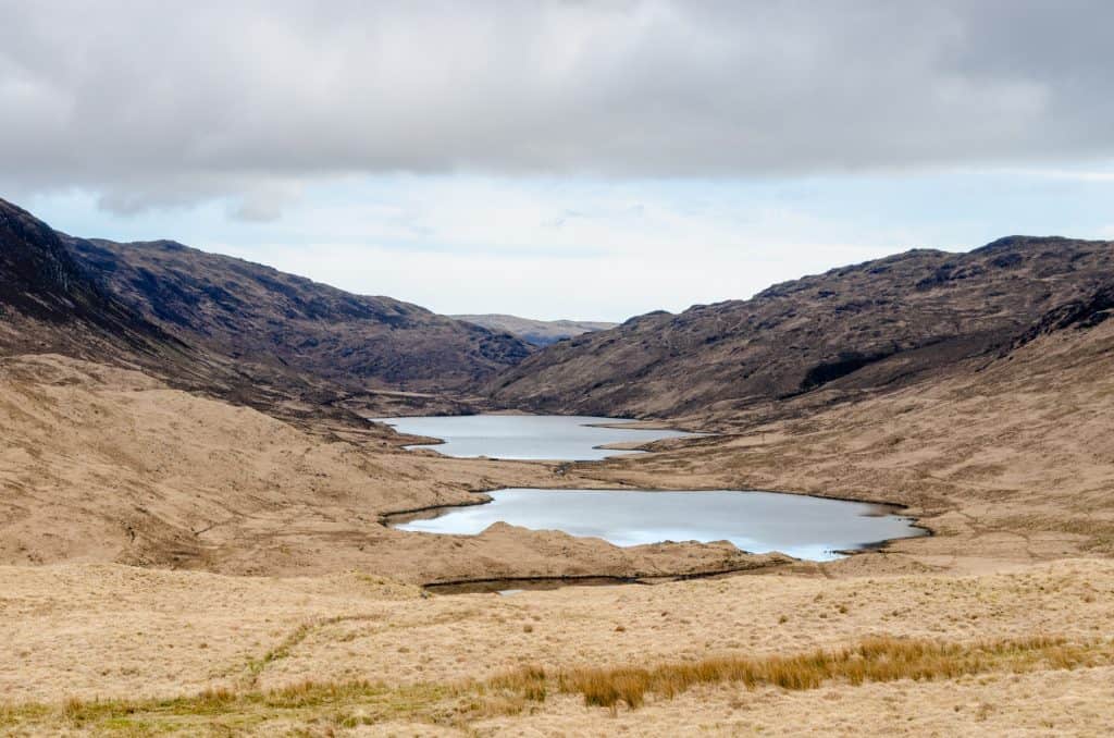 The Tree Lochs viewpoint on the Isle of Mull in early spring with mountains at back.