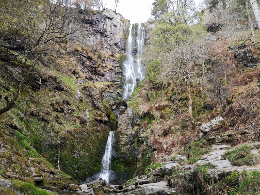 Pistyll Rhaeadr waterfall with trees in early spring, one of the best waterfalls in North Wales. North Wales is home to some of the most dramatic waterfalls in the UK, many hidden along scenic forest and mountain walking routes.