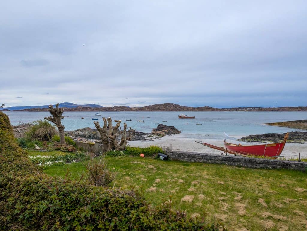 View at boats and beach on the Isle of Iona - one of the best Isle of Mull beaches.