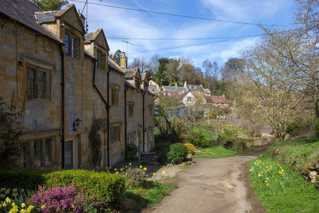 A street with historical mediaeval stone cottages on a sunny day in winter.