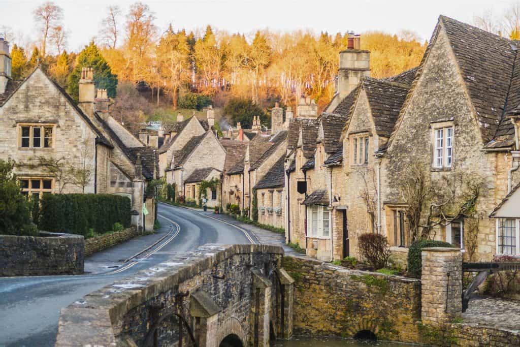 A street with historical mediaeval stone cottages and bridge in winter.