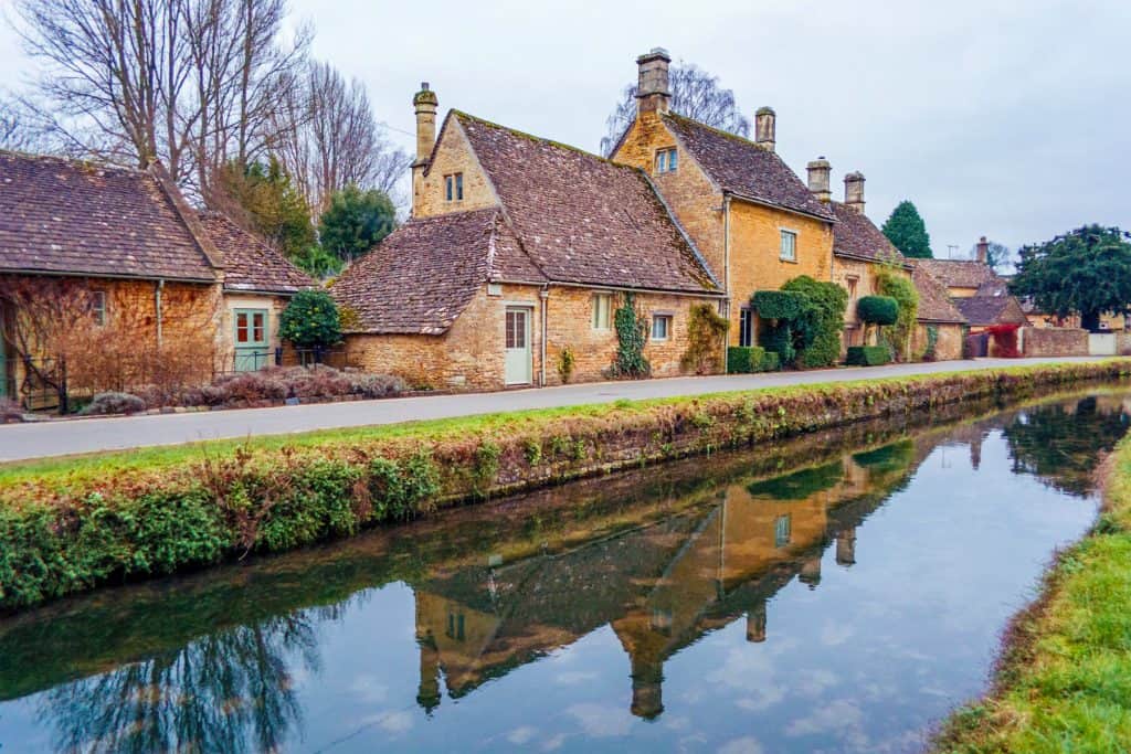 A street with historical mediaeval stone cottages and river.
