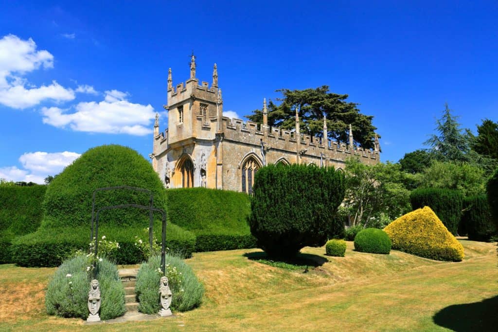 View at a historical castle with gardens on a sunny day.
