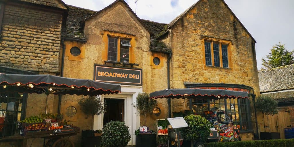 A sand-coloured cottage that is a deli in Broadway in Cotswolds.